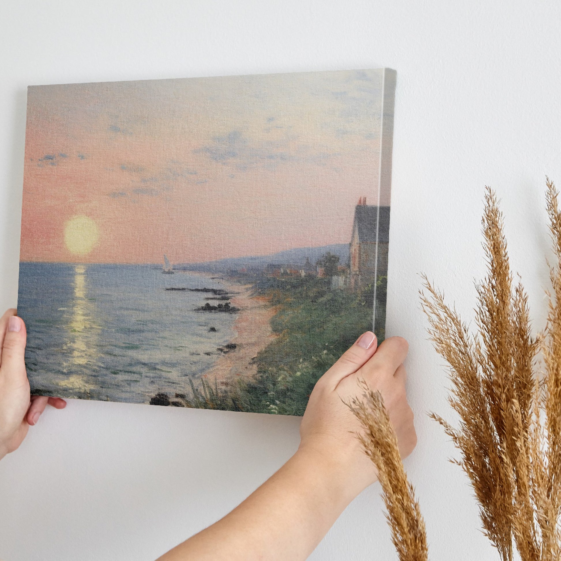 Framed canvas print of an Impressionist seascape with a sunset over the ocean and coastal village