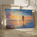 Framed canvas print of a woman walking on the beach at sunset with vibrant skies reflected in the water