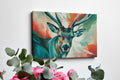 Framed canvas print of a colourful, impressionist painting of a stag with vibrant splashes of red, blue, and green