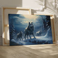 Framed canvas print of a wolf pack under a moonlit sky in a snowy forest