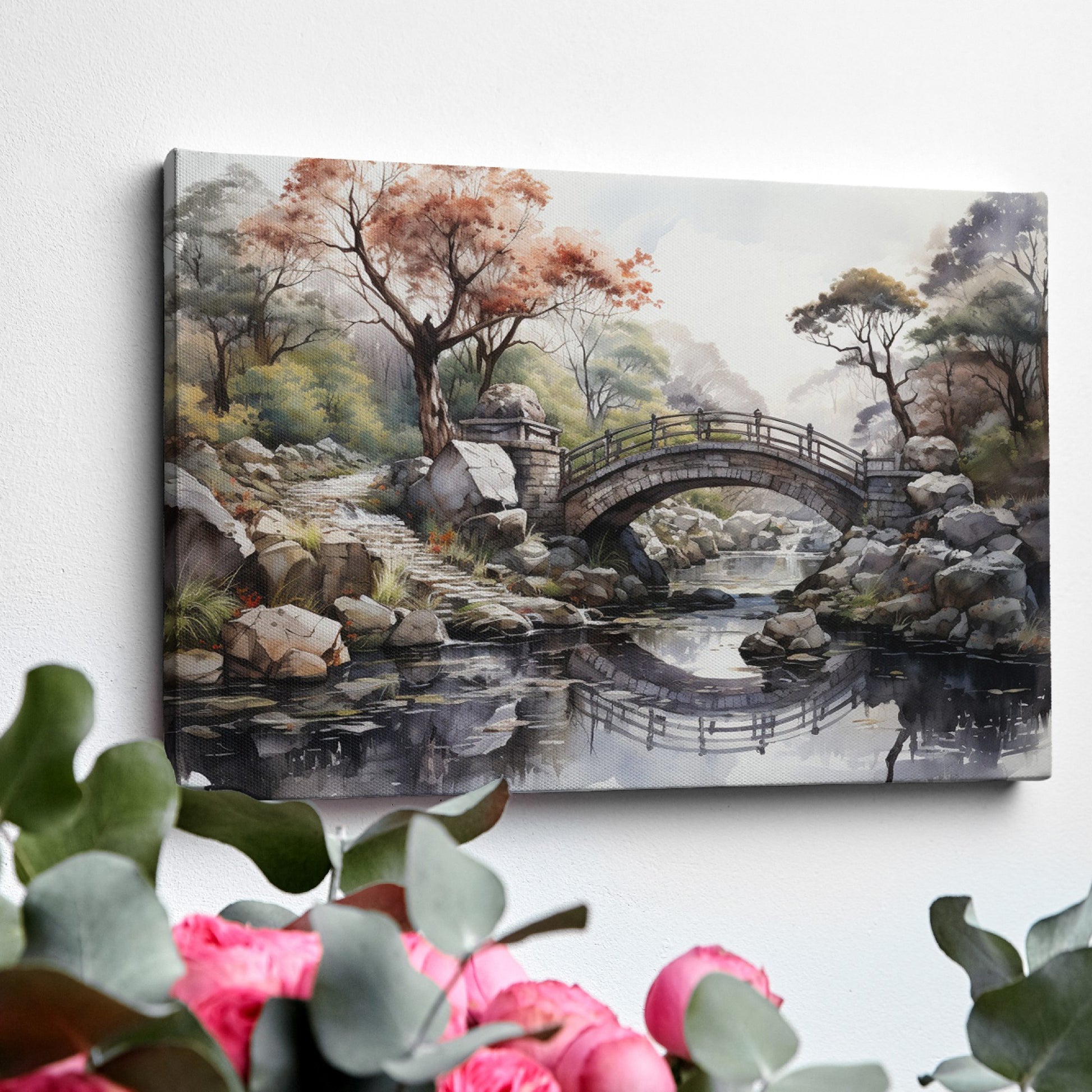 Framed canvas print of an autumnal stone bridge over a serene stream, surrounded by trees with watercolour details