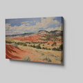 Framed canvas print of impressionistic desert hills with vivid red, earthy beige, and lush green tones