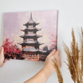 Framed canvas print of a tranquil pagoda with cherry blossoms in soft pastel hues