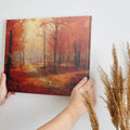 Framed canvas print of an impressionist autumn forest with vibrant red and orange leaves and a misty pathway