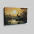 Framed canvas print of a majestic stag against a forest lake at sunrise with orange skies