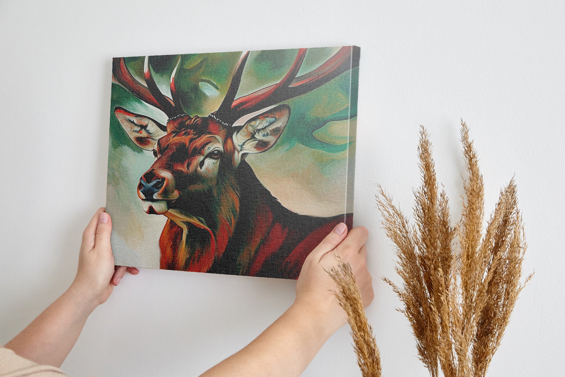 Framed canvas print of an expressive stag portrait with vibrant reds and abstract green background