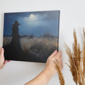 Framed canvas print of a woman in a twilight field under a glowing moon