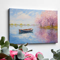 Framed canvas print of an impressionist painting featuring cherry blossoms and a serene lake with a boat