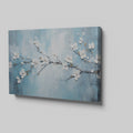 Framed canvas print of serene cherry blossoms with impasto texture on blue background