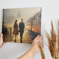 Framed canvas print of a couple's evening city walk with reflections and warm light tones