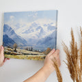 Framed canvas print of an impressionist painting featuring a snowy mountain landscape with an alpine village