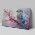 Framed canvas print of a vibrant kingfisher on a flowering cherry blossom branch