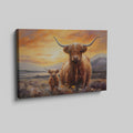 Framed canvas print of a Highland Cow and Calf against a vivid sunset landscape