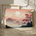 Framed canvas print of a tranquil pink sunrise over mountains with a reflective lake and silhouette of a tree