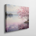 Framed canvas print of a serene cherry blossom tree by a quiet lake with pink and purple reflections