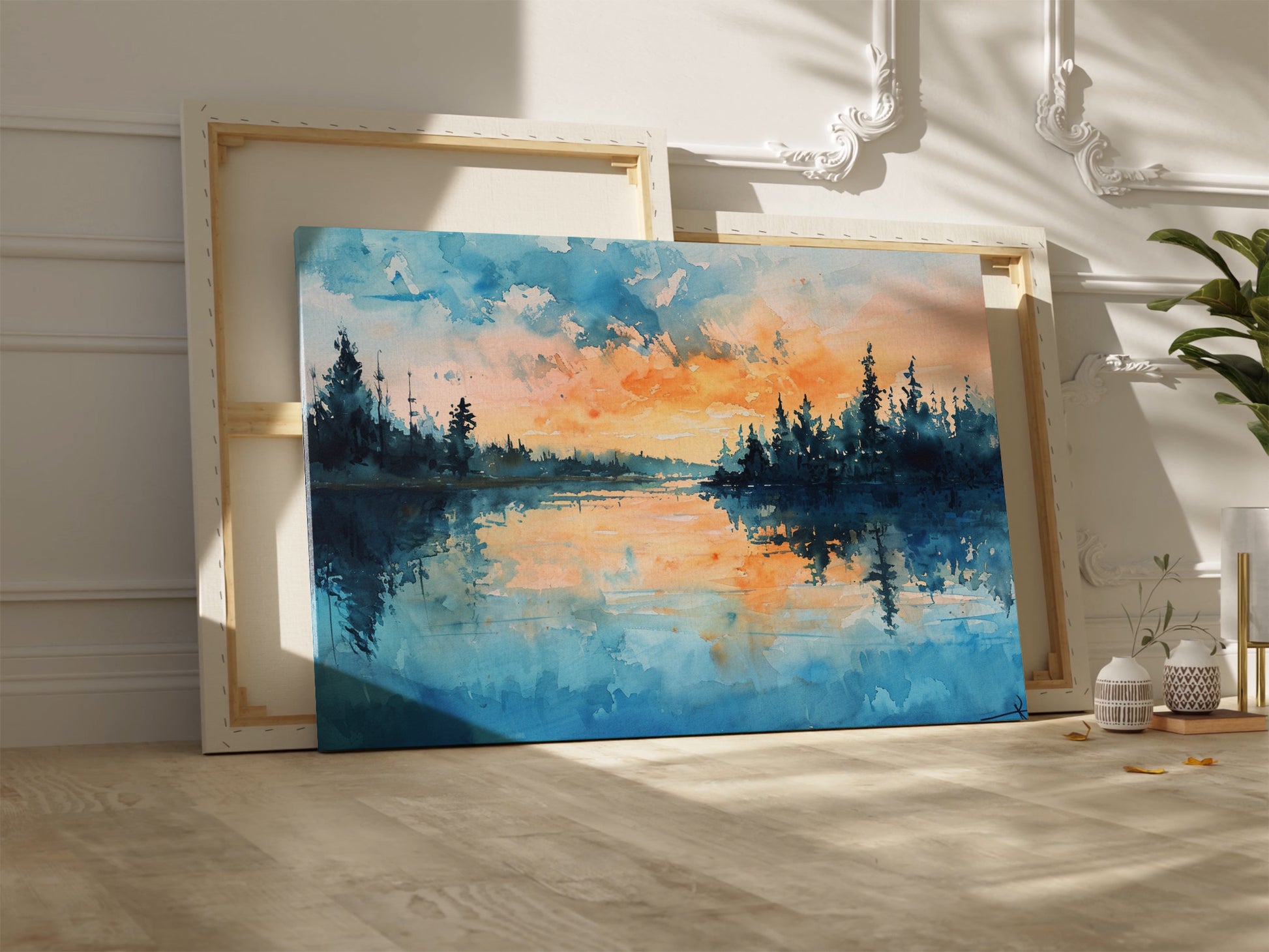 Framed canvas print of a watercolour painting with sunset over a lake and forest silhouette