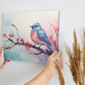 Framed canvas print of a vibrant bluebird on cherry blossom branch in watercolor