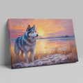 Framed canvas print of a Husky in silhouette against a colourful sunset with reflection on water