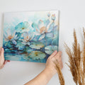 Framed canvas print of tranquil watercolor lotus pond with delicate blues and teals