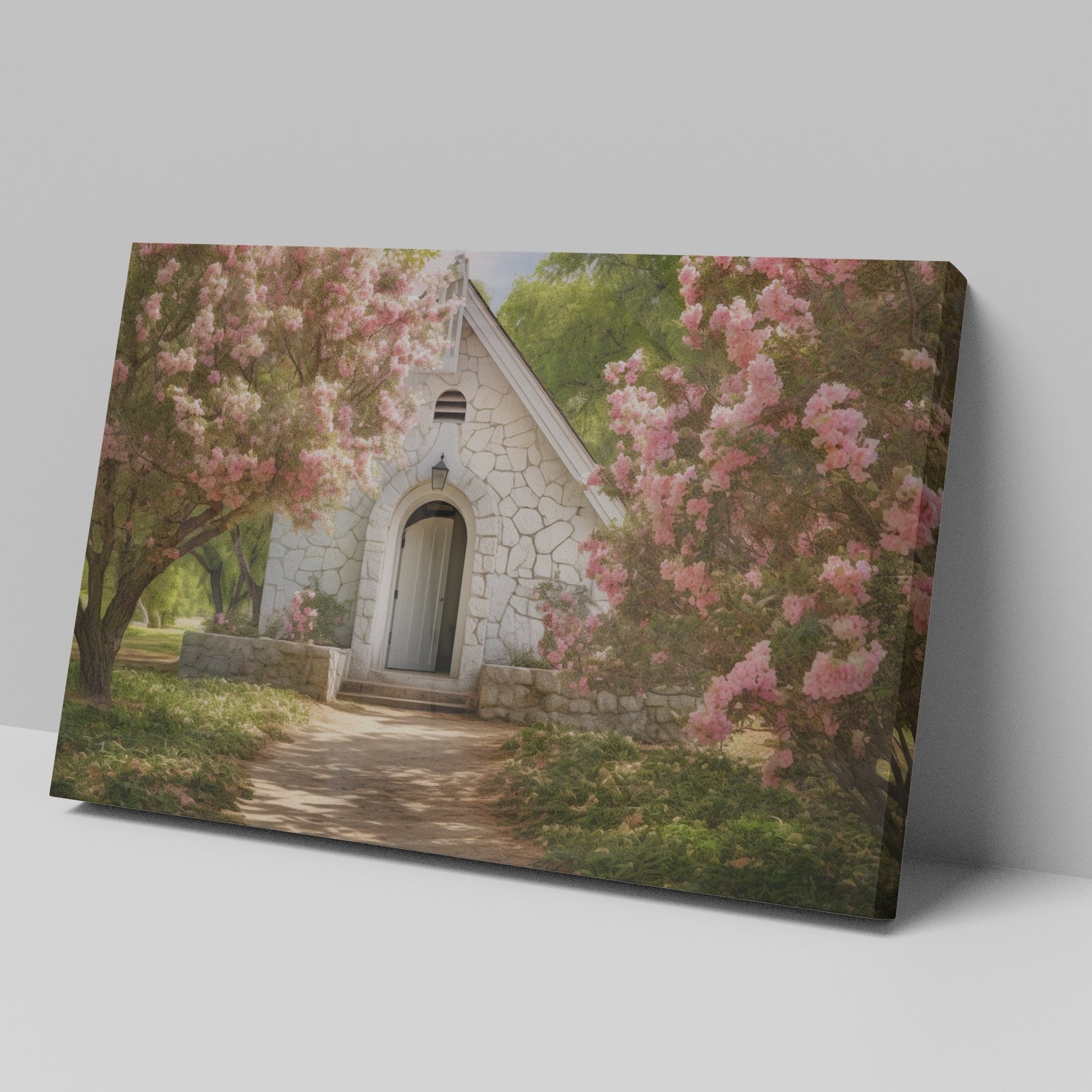 Framed canvas print of a chapel surrounded by lush pink blossom trees