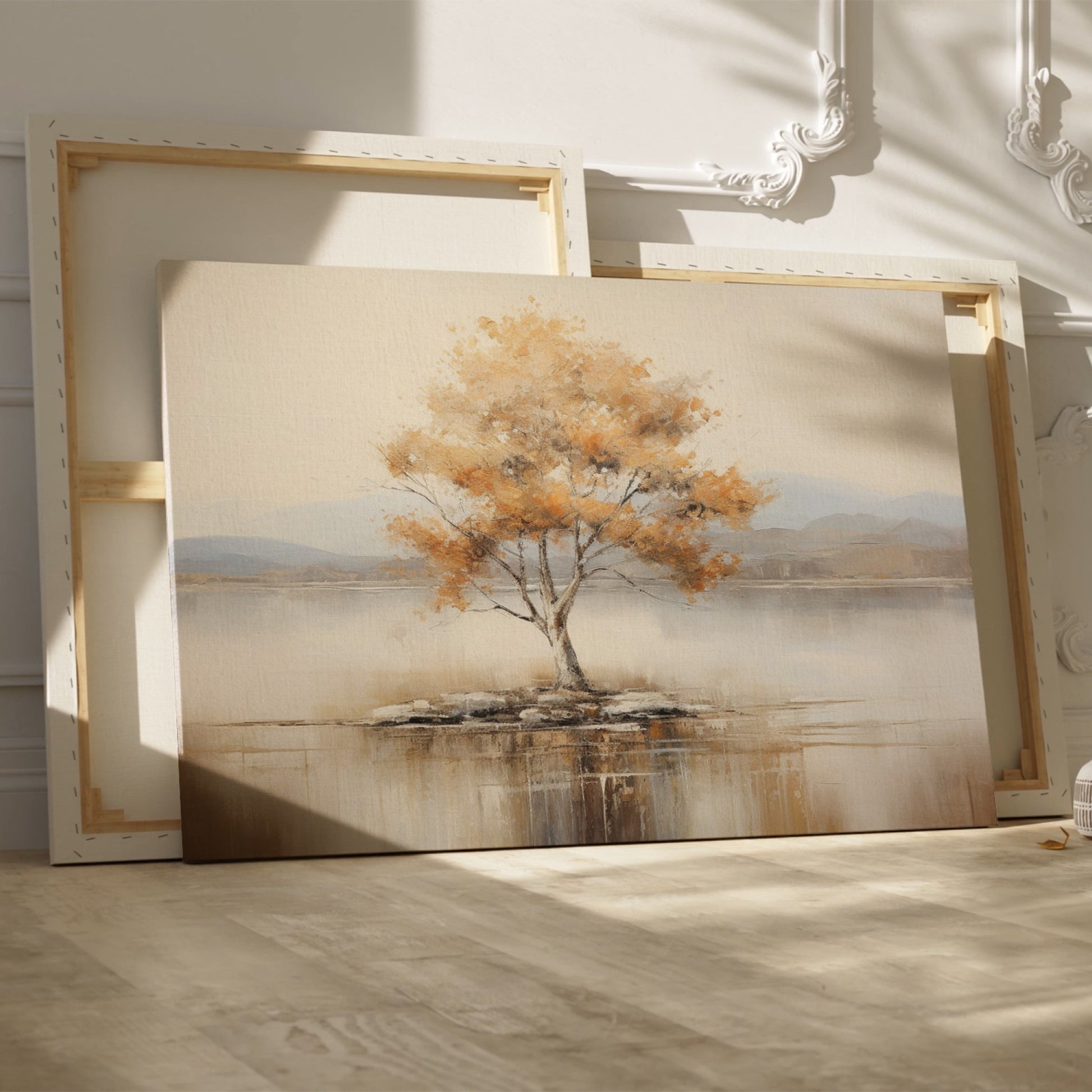 Framed canvas print of a solitary tree with autumn leaves reflected on a calm lake with warm beige, gold, and white tones