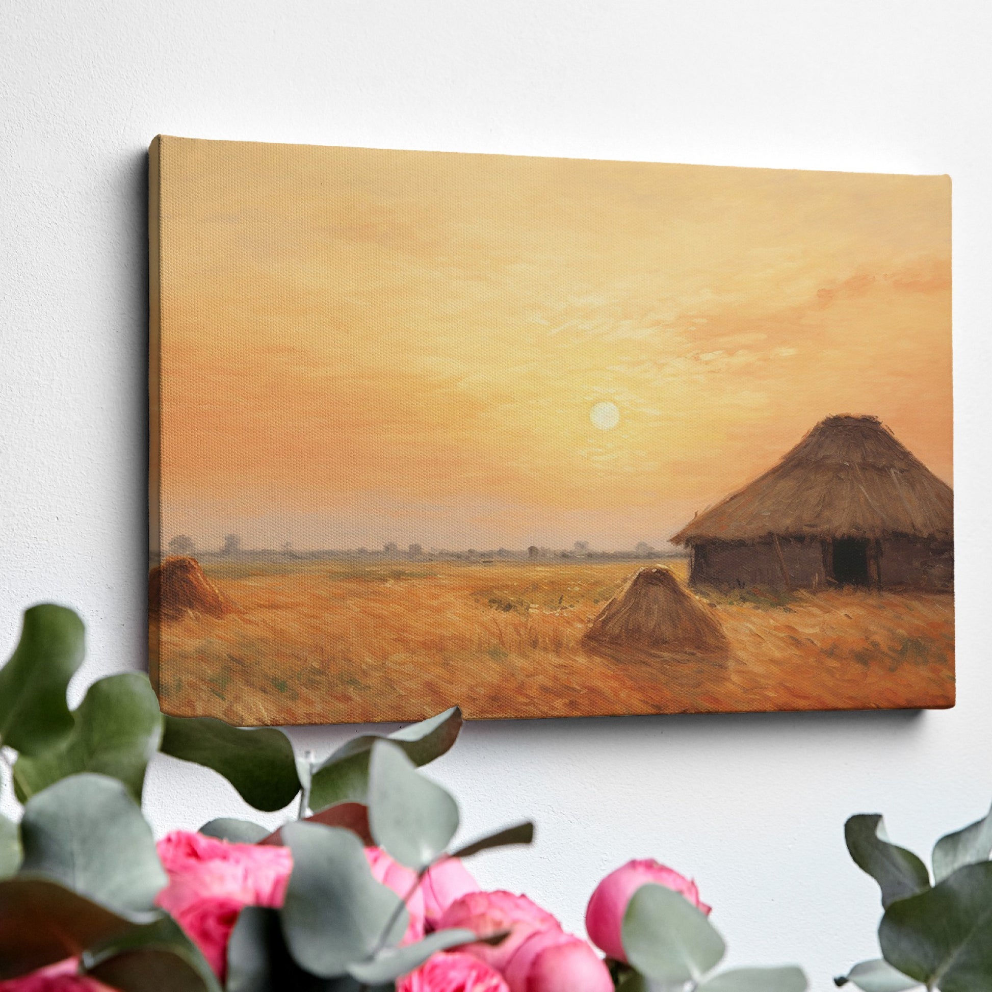 Framed canvas print of a rustic thatched cottage in a countryside landscape at sunset with warm golden and orange hues