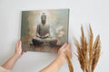 Framed canvas print of Buddha in meditation with abstract background and floral accents