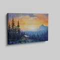 Framed canvas print of a mountain sunrise with a rustic cabin amongst pine trees