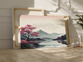 Framed canvas print of an oriental cherry blossom beside a reflective lake with mountain backdrop