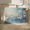 Framed canvas print of elegant white blossoms on a serene blue background with impasto textures