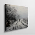 Framed canvas print of a winter landscape with a snowy path and figures walking, in a monochrome colour scheme