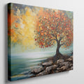 Impressionistic painting of a tree with golden autumn leaves by the coast on canvas