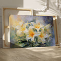 Framed canvas print of impressionist style lilies in vibrant cream and yellow hues