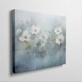 Framed canvas print of serene watercolor flowers with soft blue hues and water reflections