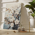 Framed canvas print of a meticulously illustrated cherry blossom branch with white flowers on a pale blue background.