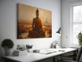 Framed canvas print of a serene meditating Buddha in golden sunset hues with temple silhouette