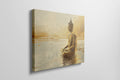 Framed canvas print of a Golden Buddha statue sitting in meditation by the water