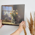 Framed canvas print of a rustic wildflower bouquet on a window sill, with soft morning light