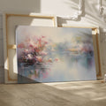 Framed canvas print depicting impressionist art of blossoming trees by a misty lake with soft pastel colours