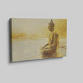 Framed canvas print of a Golden Buddha statue sitting in meditation by the water