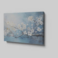 Framed canvas print of elegant white blossoms on a serene blue background with impasto textures