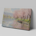 Framed canvas print of a tranquil river landscape featuring blooming cherry blossoms and a boat, in Impressionist style