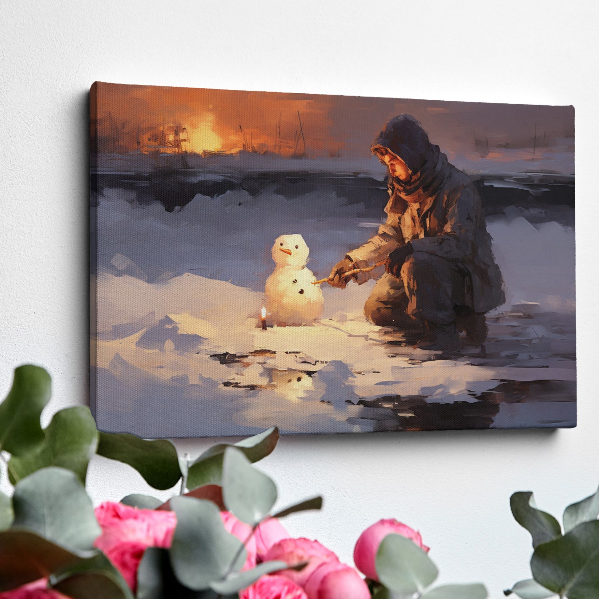 Framed canvas print of a person building a snowman at sunset with a winter landscape