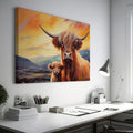 Framed canvas print of Highland cattle with calf at sunset, warm tones and mountain backdrop