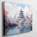 Framed canvas print of a Japanese pagoda surrounded by cherry blossoms and reflected in a tranquil pond