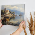 Framed canvas print of a Mediterranean coastal village with boats and serene sea reflections