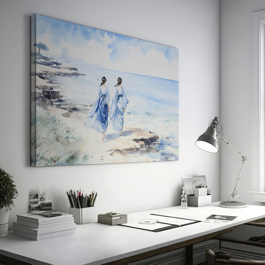 Watercolor painting of two figures in blue dresses walking along a sandy beach with the ocean in the background