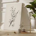 Framed canvas print of monochrome blossoms and a butterfly in a minimalist style