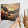 Framed canvas print of a majestic eagle flying over a canyon at sunset with warm golden and orange tones