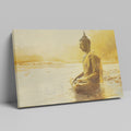 Framed canvas print of a Golden Buddha statue sitting in meditation by the water